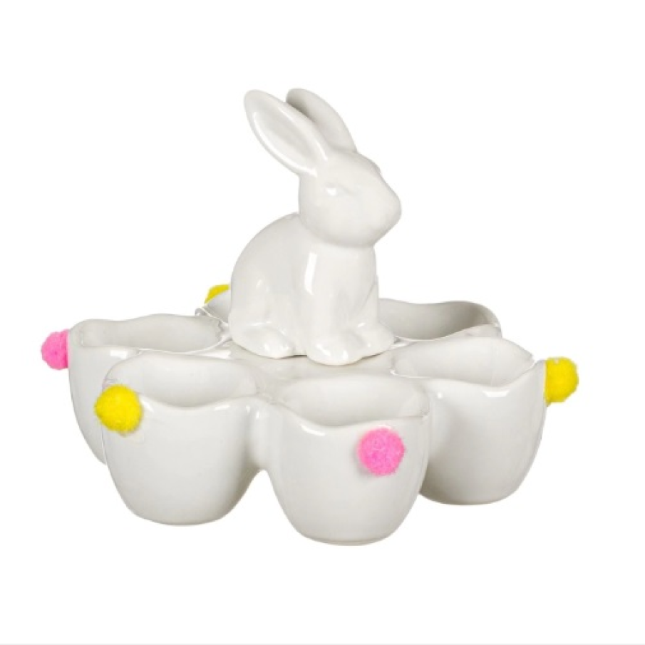 Suport decorativ pentru ouăle de Paști, confecționat din ceramică albă și decorată cu ciucuri colorați.