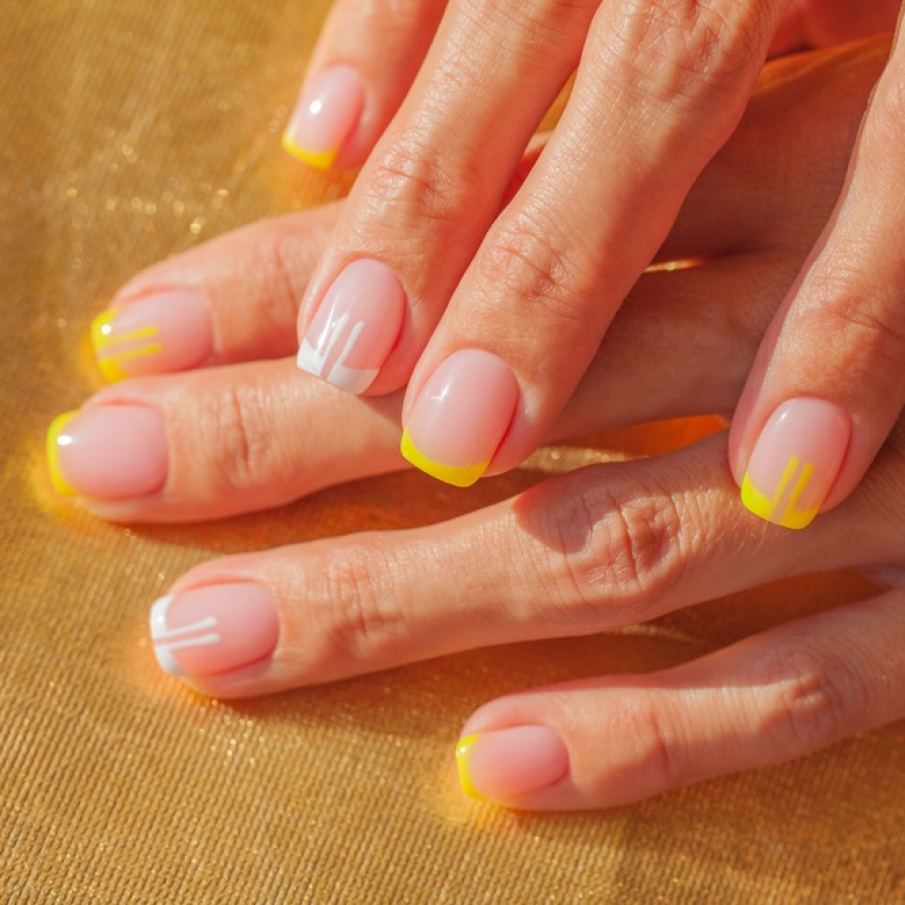 Manichiură franțuzească în galben și alb cu model 