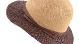 Pălărie de vară Raffaello Bettini, bicolora, în nuanța naturală a paielor bej și a unui maro cafea. Are o panglică decorativă de paie și este confecționată în Italia.