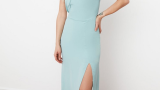 Rochie cu decolteu halter în nuanță de bleu pastel. Este asimetrică și are crăpătură pe un picior. 