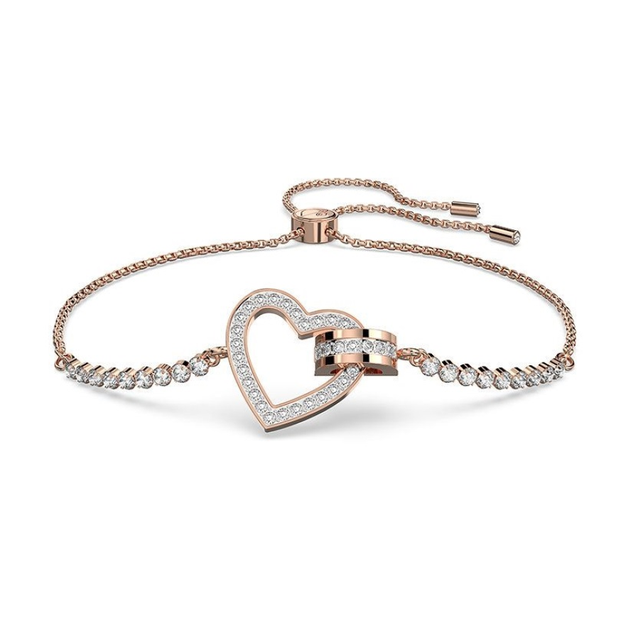 Brățară din colecția Swarovski, în nuanță de auriu, decorată cu cristale Swarovski și cu un pandantiv în formă de inimă