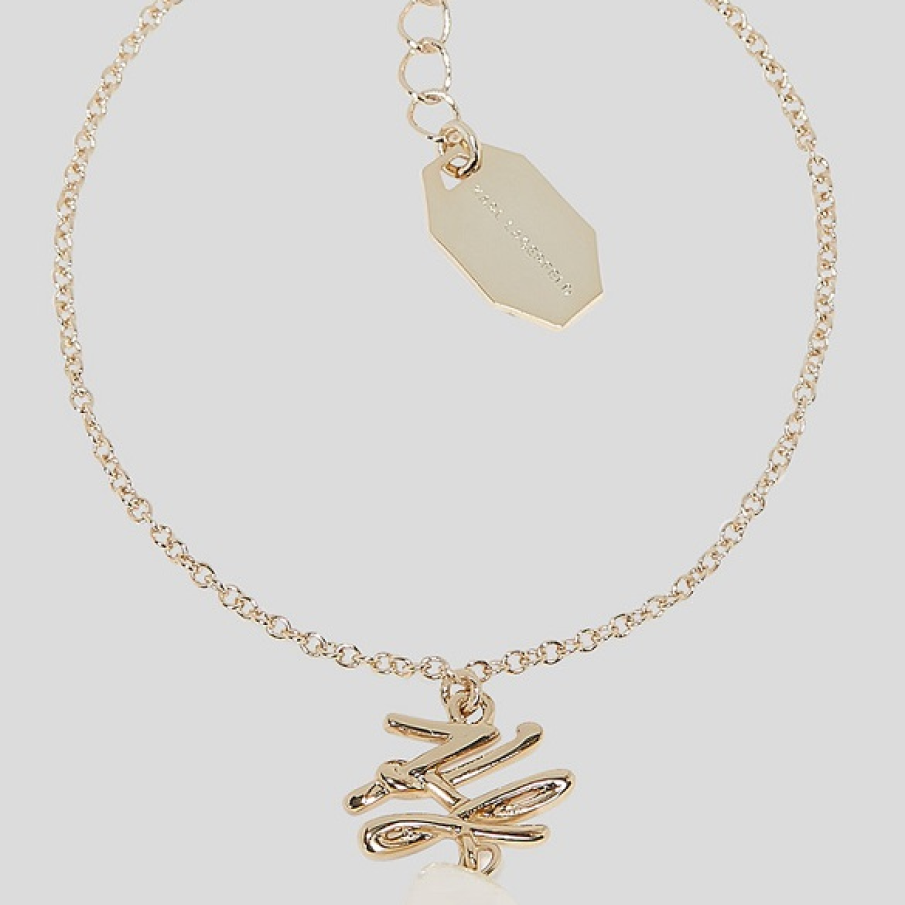 Brățară Karl Lagerfeld din alamă, cu talisman și o perlă naturală unică 