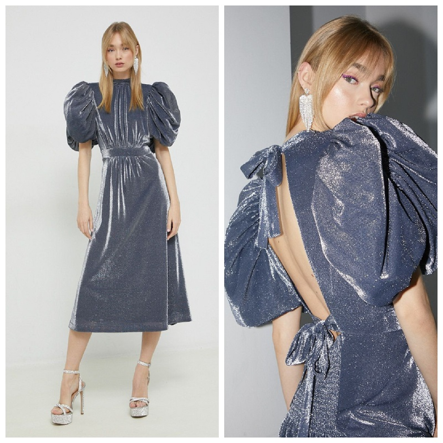 Rochie gri cu reflexii argintii din colecția Rotate. Are mâneci bufante, spatele parțial dezgolit și 2 funde de prindere în spate